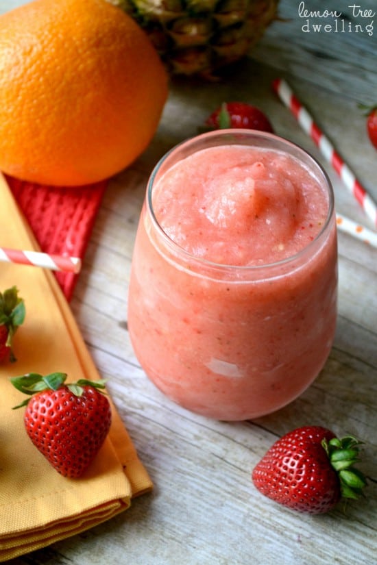 Tropical Frozen Sangria loaded with fresh strawberries, pineapple, and a hint of citrus. The perfect drink for summer!