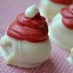 White Chocolate Raspberry Oreo Truffles are flavored with raspberry extract and decorated to look like adorable little Santa hats!