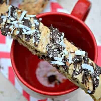 Almond Joy Biscotti is sinfully delicious! This rich biscotti is stuffed with chocolate, coconut, and almonds and drizzled with more of the same!
