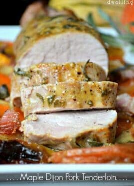 Maple Dijon Pork Tenderloin on a bed of sweet potatoes, apples, and bacon...all drizzled with a sweet and savory maple Dijon sauce and topped with fresh sage. This all in one meal is simply delicious!