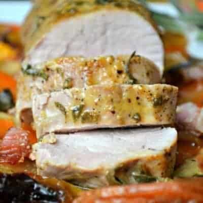 Maple Dijon Pork Tenderloin on a bed of sweet potatoes, apples, and bacon...all drizzled with a sweet and savory maple Dijon sauce and topped with fresh sage. This all in one meal is simply delicious!