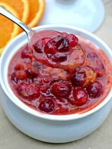 Orange Spiced Cranberry Sauce is not your basic cranberry sauce! These tart cranberries and the sweetness of oranges are mixed with flavorful spices for a Thanksgiving side dish that will please a crowd!