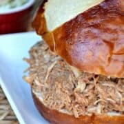 Slow Cooker Shredded Chicken is moist and juicy that it literally shreds itself! This game day sandwich is a must in your house! It is the best shredded chicken I've ever tasted....no barbecue sauce needed!!