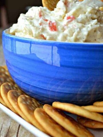 Crock Pot Crab Dip is a deliciously creamy dip made with 2 different kinds of cheese, imitation crab, and a splash of white wine. It's simple, it's delicious, and best of all.....it's made in a crock pot!
