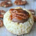 Turtle Thumbprint Macaroons are simply divine! These 4 ingredient coconut macaroons are topped with Rolos, pecans, and salted caramel sauce. Almond Joy meets Turtle...and it's love at first bite!