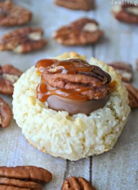 Turtle Thumbprint Macaroons are simply divine! These 4 ingredient coconut macaroons are topped with Rolos, pecans, and salted caramel sauce. Almond Joy meets Turtle...and it's love at first bite!
