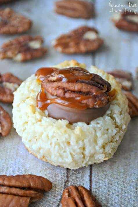 Turtle Thumbprint Macaroons are simply divine! These 4 ingredient coconut macaroons are topped with Rolos, pecans, and salted caramel sauce. Almond Joy meets Turtle...and it's love at first bite!