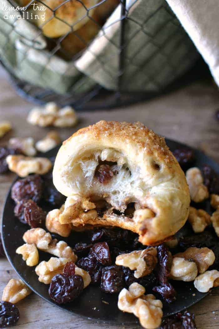 Cranberry Walnut Knots made with Rhodes Dinner Rolls are easy to make and are sure to please everyone. These delicious little rolls are stuffed with dried cranberries and walnuts and topped with a brown sugar streusel to add a little sweetness to your Thanksgiving table!