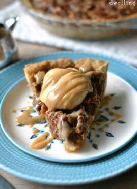 Salted Caramel Pumpkin Pecan Pie is the best Thanksgiving pie mash up ever! Delicious salted caramel and a pumpkin cheesecake filling tops this traditional pecan pie.