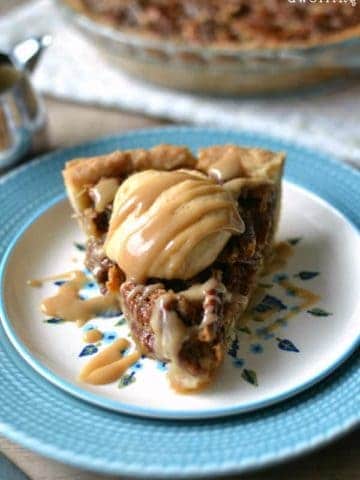 Salted Caramel Pumpkin Pecan Pie is the best Thanksgiving pie mash up ever! Delicious salted caramel and a pumpkin cheesecake filling tops this traditional pecan pie.