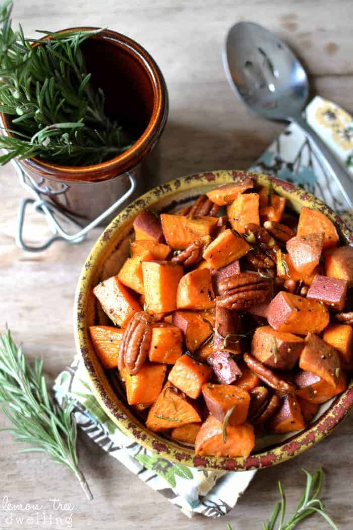 Rosemary Roasted Sweet Potatoes, simply prepared with olive oil, sea salt, fresh cracked pepper, and a touch of maple syrup, tossed with toasted pecans for extra crunch! This simply elegant side dish is perfect for any table