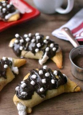 Hot Chocolate Crescent Rolls - stuffed with sweet hot chocolate cream cheese and marshmallow fluff and drizzled in milk chocolate and more marshmallows!