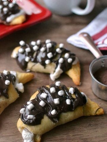 Hot Chocolate Crescent Rolls - stuffed with sweet hot chocolate cream cheese and marshmallow fluff and drizzled in milk chocolate and more marshmallows!