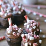 Peppermint Hot Chocolate Cookie Cups are a deliciously sinful dessert topped with peppermint chocolate buttercream, peppermint candies, and marshmallow bits.