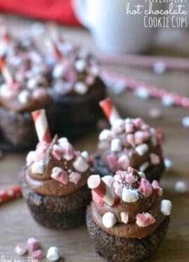 Peppermint Hot Chocolate Cookie Cups are a deliciously sinful dessert topped with peppermint chocolate buttercream, peppermint candies, and marshmallow bits.