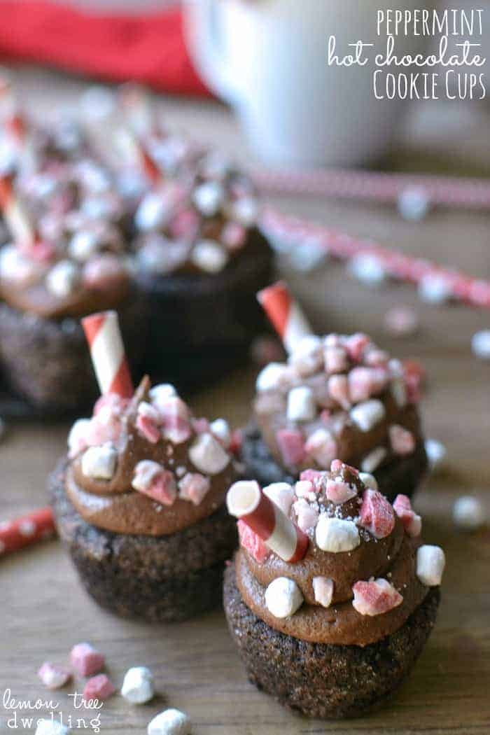 Peppermint Hot Chocolate Cookie Cups are a deliciously sinful dessert topped with peppermint chocolate buttercream, peppermint candies, and marshmallow bits.