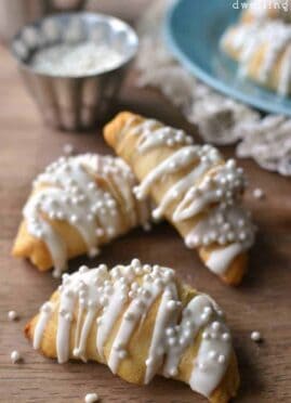 White Chocolate Almond Crescent Rolls will please any crowd and are so simple to make. These easy rolls are not only delicious, they're so pretty, too! Perfect for New Year's morning, a wedding shower, or any special occasion.