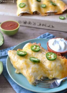 These Creamy Chicken Enchiladas are the BEST enchiladas ever! Perfect to make ahead and even freeze, they are an awesome quick dinner for feeding a crowd.