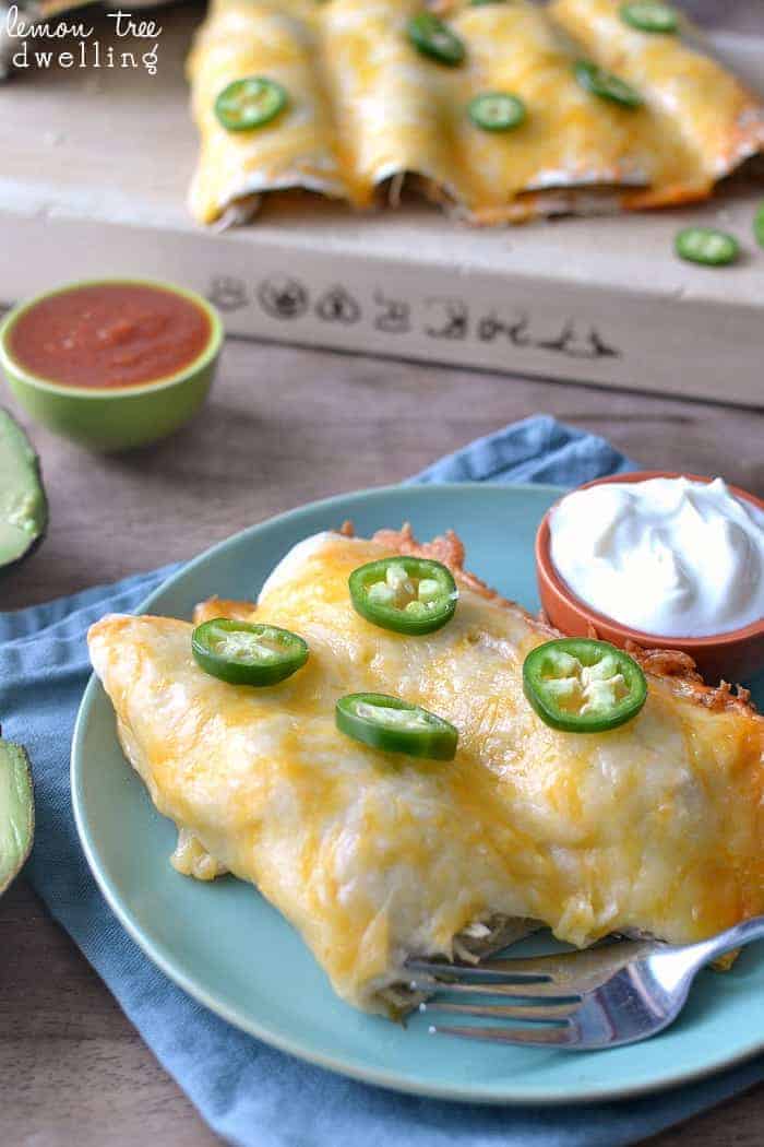 These Creamy Chicken Enchiladas are the BEST enchiladas ever! Perfect to make ahead and even freeze, they are an awesome quick dinner for feeding a crowd.