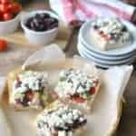 Greek Veggie Pizza Squares with crescent roll crust, tzatziki cream cheese, fresh Greek vegetables, and crumbled feta cheese!