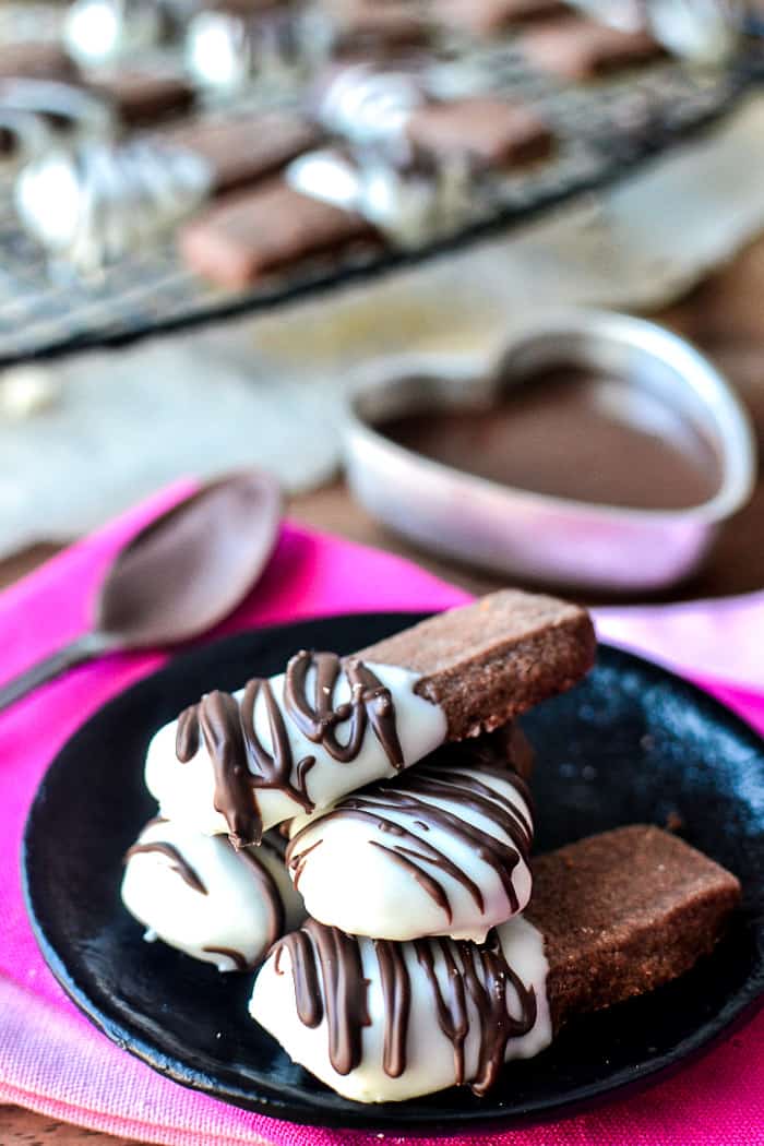 4 Chocolate Shortbread Cookies stacked on a plate