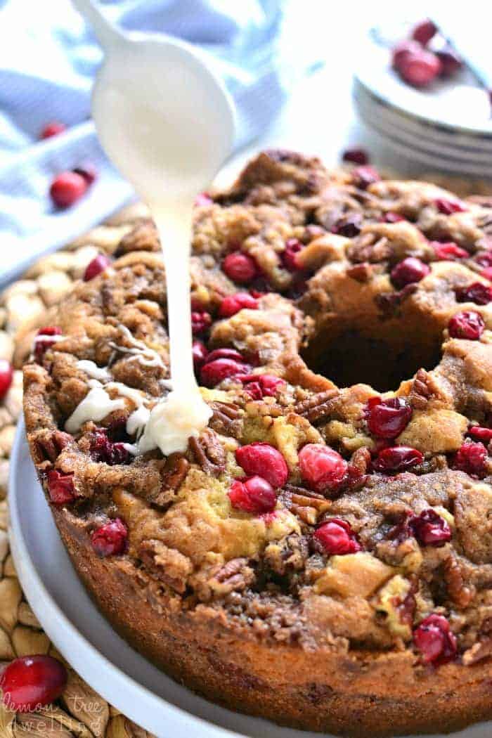 Cranberry-Pecan Coffee Cake is packed with fresh cranberries, pecans, and brown sugar streusel, then topped with a creamy vanilla glaze. Make this coffee cake recipe for breakfast or dessert