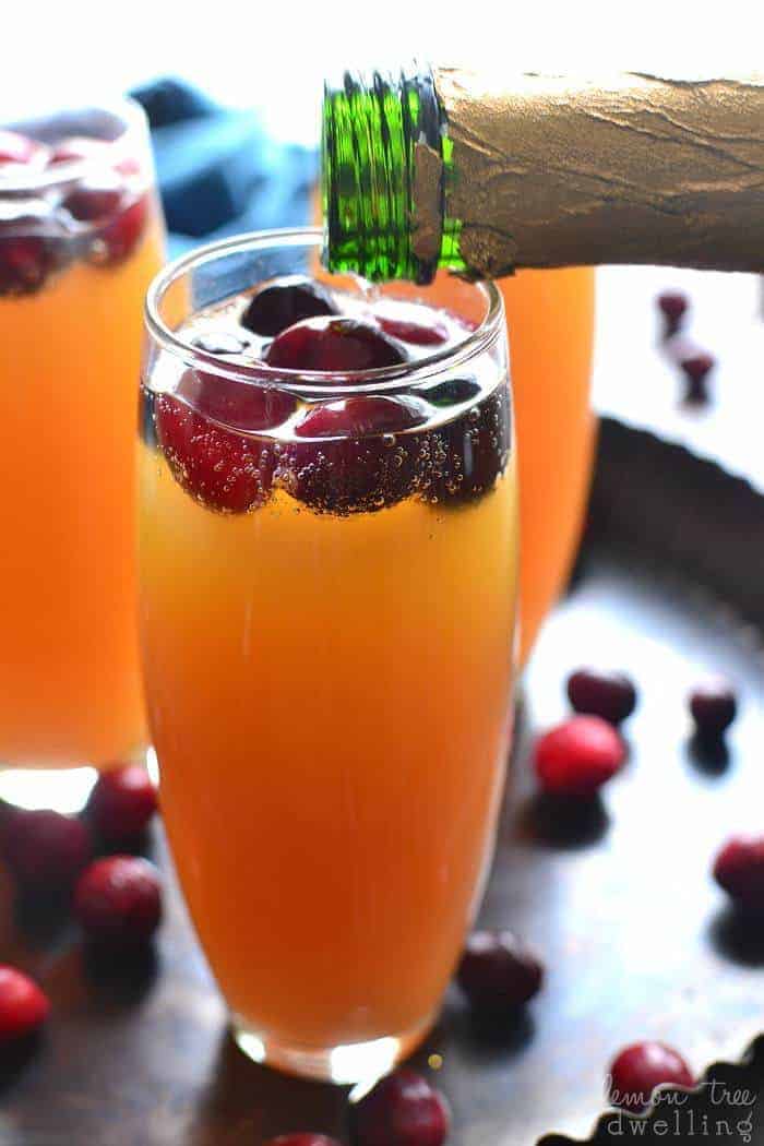 Cranberry Orange Mimosas are a deliciously sweet brunch cocktail and perfect for any celebration! This easy drink can be a beautiful accompaniment to any holiday table