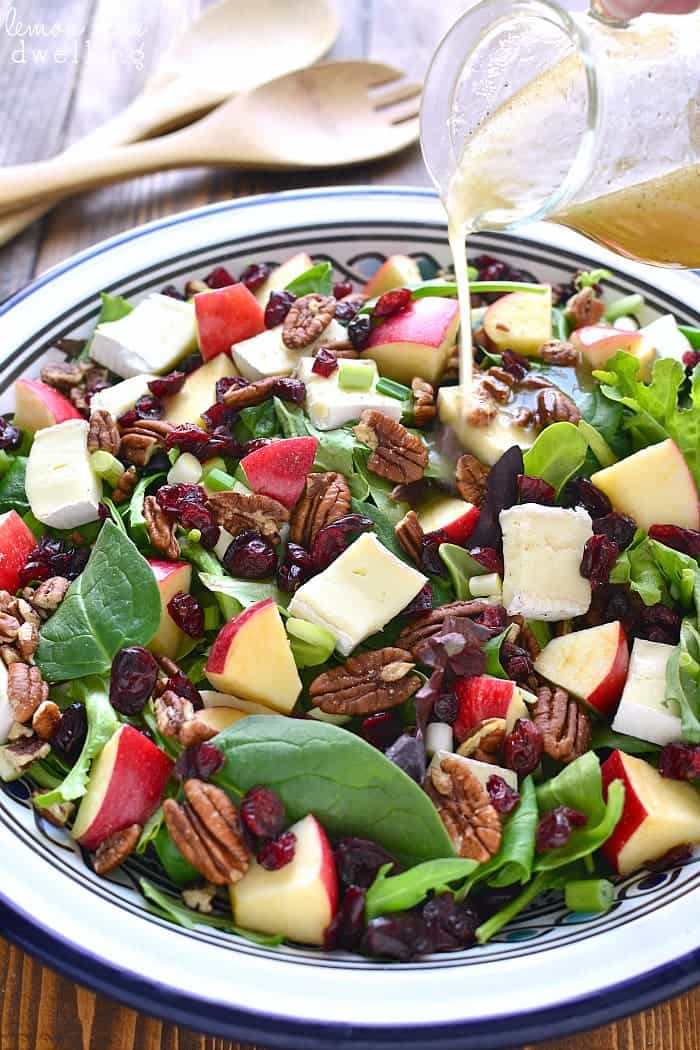 Dressing pouring on Apple Brie Salad