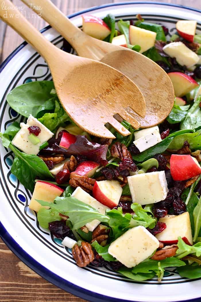 Apple Brie Salad in bowl with serving spoons 