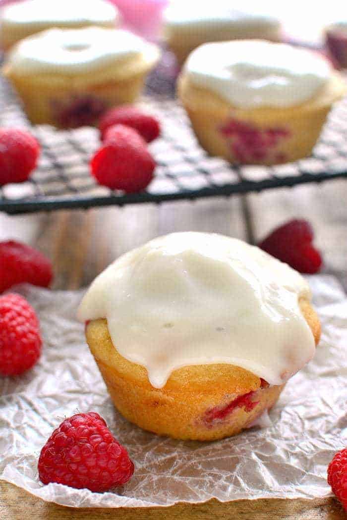 These Iced Raspberry Muffins are loaded with fresh raspberries and topped with a deliciously sweet cream cheese icing.