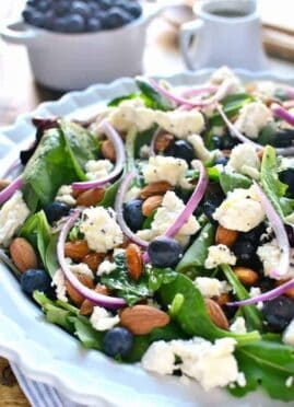 Blueberry Feta Salad is your new go-to salad recipe for spring! It combines fresh blueberries with feta cheese, almonds, and a lemon poppy seed vinaigrette dressing.