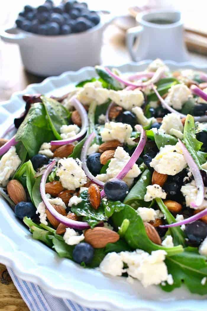 Blueberry Feta Salad is your new go-to salad recipe for spring! It combines fresh blueberries with feta cheese, almonds, and a lemon poppy seed vinaigrette dressing.