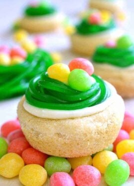 These Easter Egg Cookie Cups are easy, adorable, and so delicious! These quick and easy sugar cookies are topped with lemon buttercream, and Easter candy.