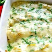 These Roasted Vegetable Enchiladas are packed with veggies and beans then topped with a creamy chile verde sauce and melted cheese. A perfect meatless meal