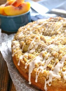 homemade peach cobbler coffee cake with cinnamon sugar drizzled on top