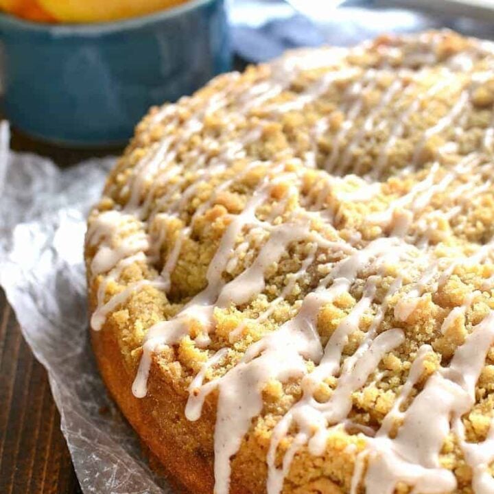 homemade peach cobbler coffee cake with cinnamon sugar drizzled on top