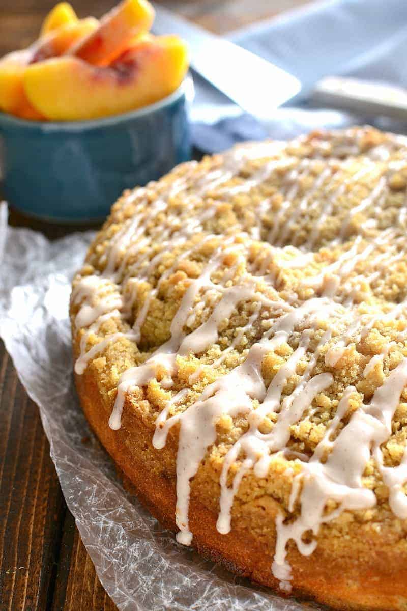 homemade peach cobbler coffee cake with cinnamon sugar drizzled on top