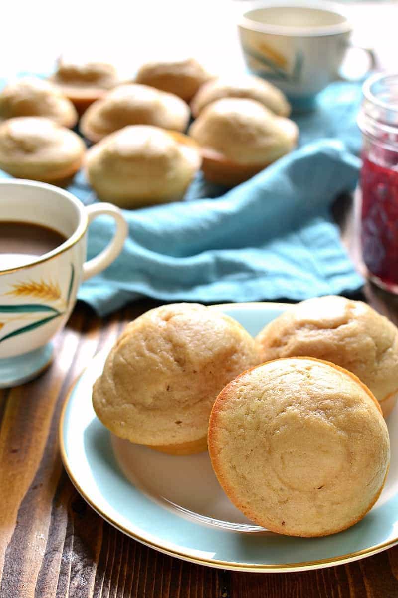 a plate of Very Vanilla Muffins and a cup of black coffee