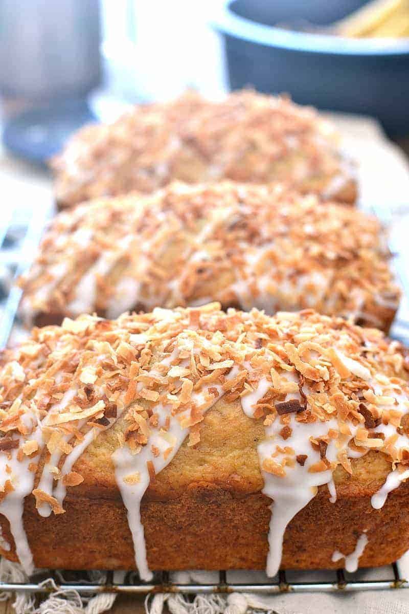 3 loaves of Coconut Rum Banana Bread on a cooling rack