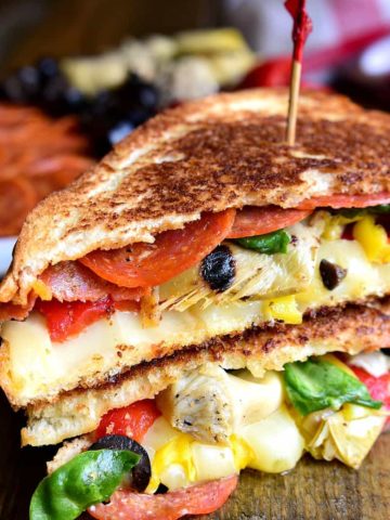 Italian Antipasto Grilled Cheese Sandwiches are a delicious twist on grilled cheese. These hot sandwiches are loaded with pepperoni, cheese, artichokes, olives, and roasted red peppers!