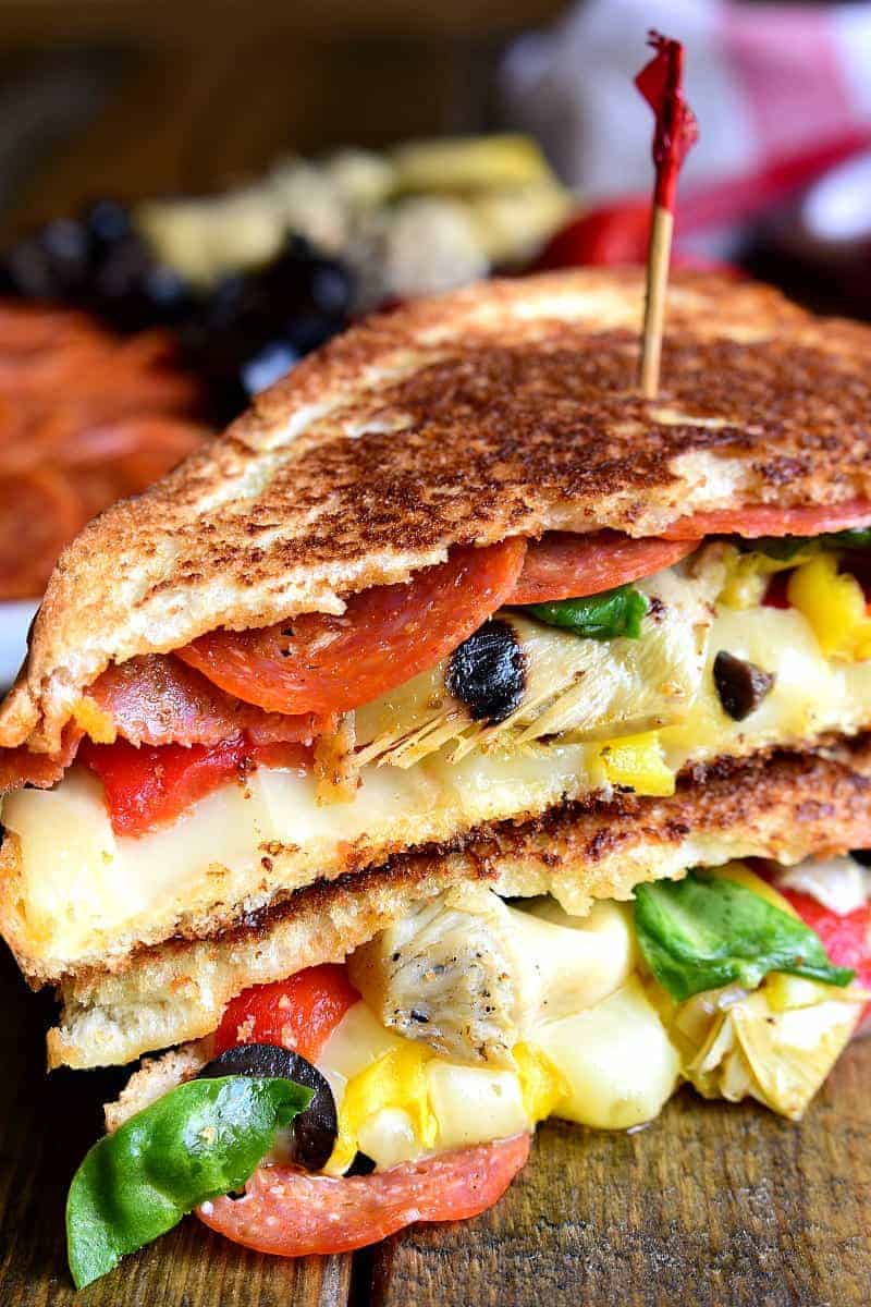 Italian Antipasto Grilled Cheese Sandwiches are a delicious twist on grilled cheese. These hot sandwiches are loaded with pepperoni, cheese, artichokes, olives, and roasted red peppers!