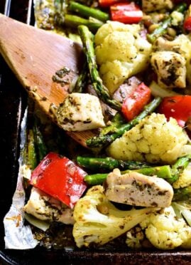 This Sheet Pan Pesto Chicken is loaded with veggies and packed with delicious flavor! This one pan dinner is prepped in less than 10 minutes and a complete meal!