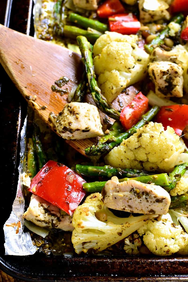 This Sheet Pan Pesto Chicken is loaded with veggies and packed with delicious flavor! This one pan dinner is prepped in less than 10 minutes and a complete meal!