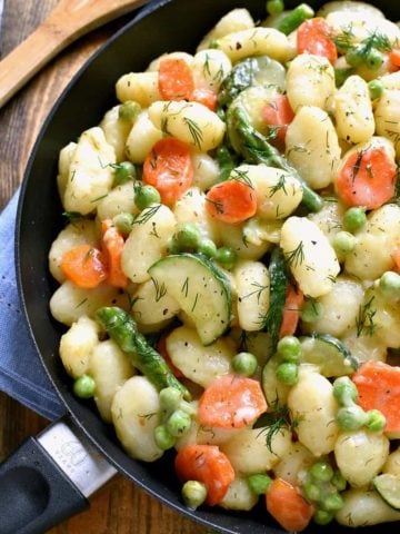 This Spring Vegetable Gnocchi is creamy, delicious, and comfort food at its finest. This gnocchi is loaded with fresh vegetables and comes together in under 20 minutes.