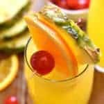 tropical mimosas garnished with fresh fruit