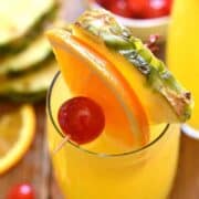 tropical mimosas garnished with fresh fruit