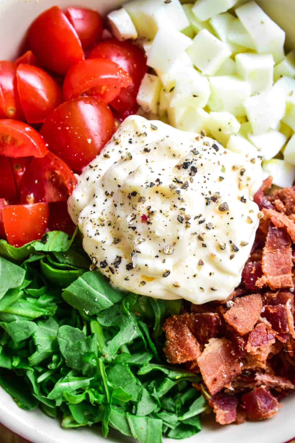 This BLT Egg Salad combines two classics in one delicious dish that's sure to become a new favorite! This egg salad has all the creamy deliciousness you expect from egg salad, plus the bold flavors of bacon, lettuce, and tomato. Perfect for weekday lunches and summer picnics, and a great way to use up leftover Easter eggs. If you love egg salad, you'll LOVE this yummy twist!