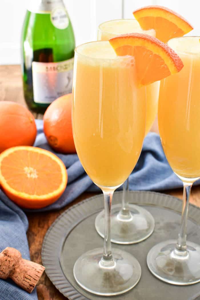 Take your favorite breakfast cocktail to the next level with these delicious Orange Creamsicle Mimosas! They combine the fun of childhood with the deliciousness of adulthood....all in one glass. Made with 4 simple ingredients, these mimosas are just the right blend of creamy, sweet, and bubbly. Perfect for weekend brunches, ladies' nights, or lazy days by the pool. If you love mimosas (and who doesn't!?) you'll love this fun, creamy, YUMMY twist!