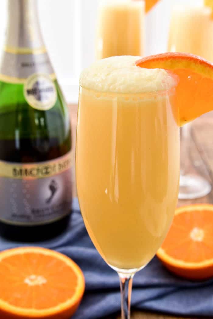 Take your favorite breakfast cocktail to the next level with these delicious Orange Creamsicle Mimosas! They combine the fun of childhood with the deliciousness of adulthood....all in one glass. Made with 4 simple ingredients, these mimosas are just the right blend of creamy, sweet, and bubbly. Perfect for weekend brunches, ladies' nights, or lazy days by the pool. If you love mimosas (and who doesn't!?) you'll love this fun, creamy, YUMMY twist!