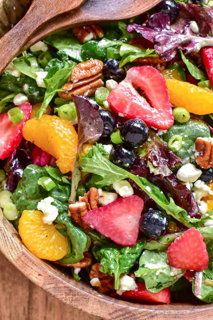 Take advantage of fresh berry season with this delicious Summer Strawberry Salad. Loaded with fresh strawberries, blueberries, mandarin oranges, pecans, goat cheese, and sparkling orange vinaigrette, this salad is the perfect balance of savory, sweet, crunchy, creamy, and YUMMY!